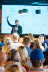 Wall Mural - back view of multiethnic business professionals listening to speaker giving presentation in conferen