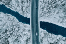 Aerial Top View Of Snow Winter Road With Cars Over Blue River