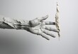 Artistic design of an arm in plaster with open hand and fingers between the crack of a grey wall. Contemporary art concept