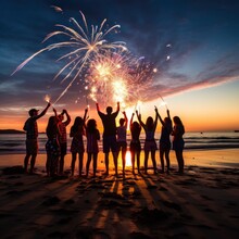 A Festive Image Of People Gathered On A Beach With Sparklers