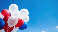 Balloons In Patriotic Colors Floating Against A Bright Blue Sky