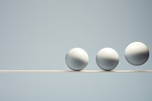  A Group Of Three Eggs Sitting On Top Of A Wooden Balance Beam In Front Of A Light Blue Background With A Line Of Three Eggs On Each Side Of The Same Line.