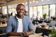 © esp2k - Young African American Man Working on Laptop in Modern Office