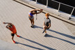 © Drobot Dean - Top view group of three active people doing workout outdoors on bridge