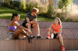 © Drobot Dean - Group of three positive people resting after workout outdoors