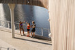 © Drobot Dean - Group of active fitness people giving each other high five during workout on city waterfront