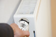 hand with radiator. Hand regulation Close-up of the heating thermostat with radiator in Germany. Temperature Of Radiator Thermostat