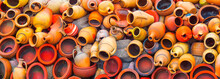 The backyard of a pottery workshop. Wide background consisting of clay pots, stoneware jugs and other handmade unglazed ceramics.