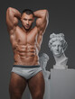 Leinwandbild Motiv Rugged Beauty: Muscular Man and Ancient Greek Statues