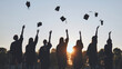 © Довидович Михаил - Silhouettes of Happy college graduates tossing their caps up at sunset.