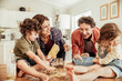 © Marko Geber - Young family with small children baking together in kitchen having fun