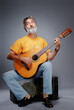© luengo_ua - Aged bearded man with an acoustic guitar