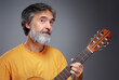 © luengo_ua - Aged bearded man with an acoustic guitar