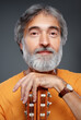 © luengo_ua - Aged bearded man with an acoustic guitar