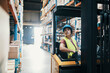 © Davor - Woman operating forklift in large warehouse
