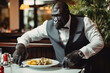 © serperm73 - Portrait of humanized gorilla is a chef in the hotel restaurant. Cook gorilla is decorating dish.