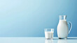copy space, stockphoto, light blue background, glass filled with milk, jug half filled with milk next to the glass. Healthy food concept. National milk day.