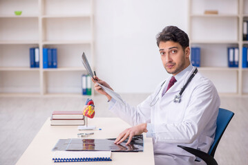 Wall Mural - Young male doctor radiologist working in the clinic