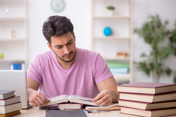 Wall Mural - Young male student sitting in the classroom