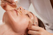 Close-up of the process of a beautician applying oil to a woman's face with a pipette Facial skin care with medicated cosmetic oil. hold professional cure serum bottle oil treatment cosmetologist