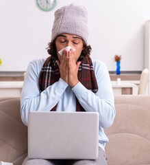 Wall Mural - Young man suffering from flu at home