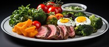 On A White Plate, The Chef Carefully Arranged A Colorful Breakfast Spread, Consisting Of Green Vegetables, Succulent Meat, And A Variety Of Healthy Foods. The Meal, A Perfect Blend Of Flavors And