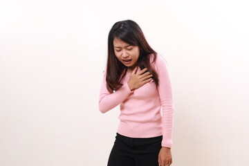 Wall Mural - Pressure in the chest. Close-up photo of a stressed woman who is suffering from a chest pain and touching her chest