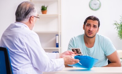 Wall Mural - Young male patient visiting experienced doctor