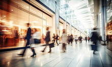 Motion Blur Of People With Shopping Bags In A Busy Shopping Mall. Retail Sale And Discount
