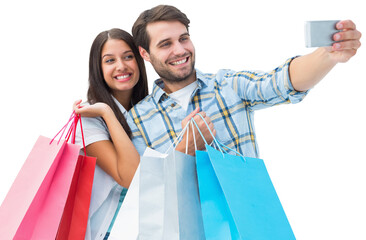 Sticker - Digital png photo of caucasian couple with shopping bags and smartphone on transparent background