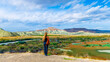 © M.studio - Woman tourist in Nallihan Bird Sanctuary,  national park with varitety of birds and colored mountain, near Ankara