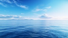 A Body Of Water With A Blue Sky And Clouds