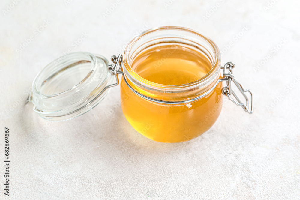 Jar with sweet honey on white background