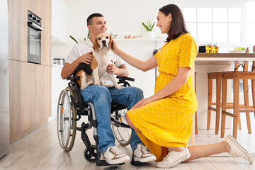 Poster - Young man in wheelchair with Beagle dog and his pregnant wife at home