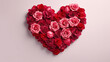 Heart made of red and pink roses on a pink background. Valentine's Day.