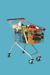 Sticker - Shopping cart full of food on blue background