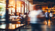 Blurred motion of a people walking in a busy cafe with customers sitting at tables, warm and cozy atmosphere