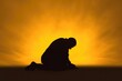 Christian prayer. Man on his knees praying on sunset background. Kneeling prayer to God. Worship and praise.