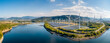 Wind turbines and solar park on a river, a panorama of energy generation from wind and sun.