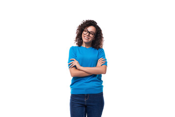 Wall Mural - friendly young curly brunette woman in blue t-shirt on white background