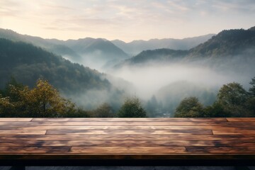 Sticker - Wooden table overlooking a misty mountain valley at sunrise.