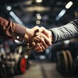 Handshake between a mechanic and a customer in an auto repair shop