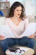 © auremar - shocked young woman reading documents