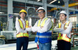 © NOPPHINAN - Portrait Team of Asian male engineers and technicians in safety helmets and wearing safety vests standing with arms crossed in the factory.