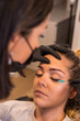 © unai - Applying mascara to eyelashes of a woman in a salon