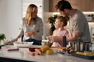 Caucasian family of three cooking before Christmas