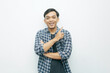 © Galih Yoga - Portrait Indonesian Asian young man smiling with index finger pointing up. Casual concept isolated white background