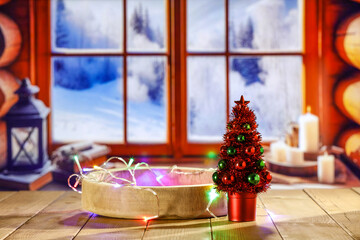 Wall Mural - Wooden retro yellow table and blurred background of window sill. Christmas tree and empty space for your decoration. Natural light and magic time. Mockup background and cold december time.