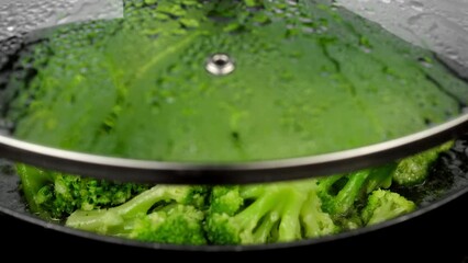 Wall Mural - Fresh green broccoli frying on a pan. Healthy food, vegetarian cuisine