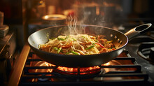 Wok Noodles With Vegetables Are Cooked In A Frying Pan